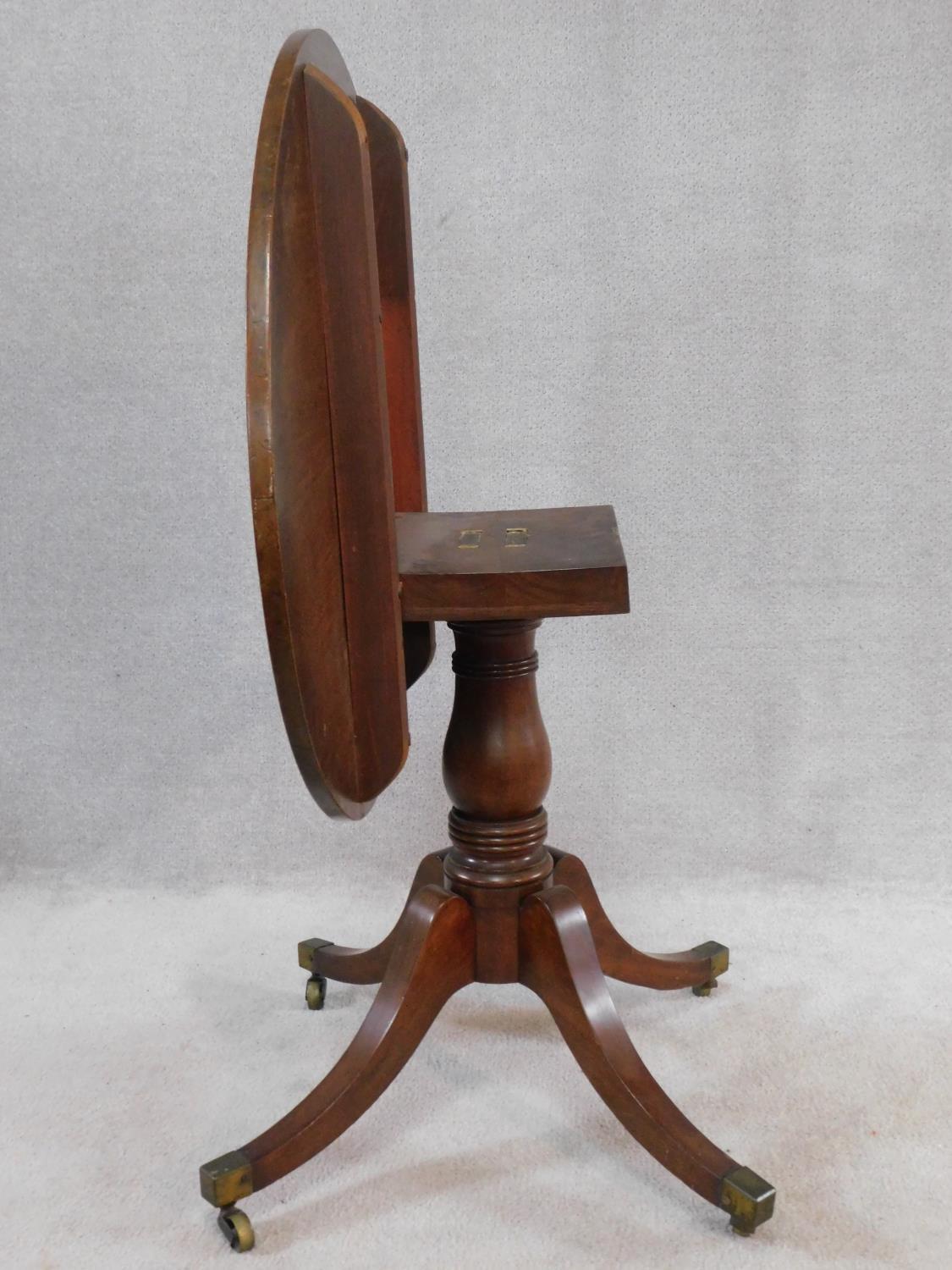 A 19th century mahogany tilt top tea table on swept quadruped supports terminating in brass cap - Image 4 of 5