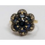 A vintage sapphire and diamond floral design 18ct yellow gold cluster ring. Set with seven round