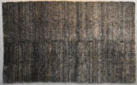 A contemporary rug with scrolling design on a field of shades of taupe and grey. L.270x180cm