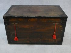 A 19th century metal bound travelling trunk with twin locks and carrying handles and a zinc lined