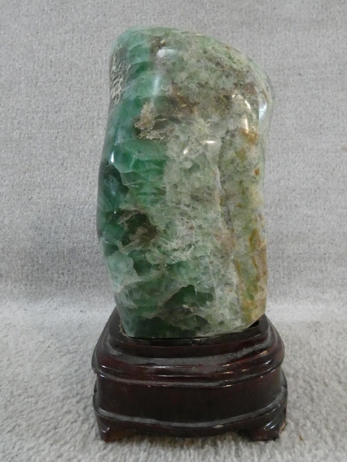 A large polished Fluorite crystal boulder mounted on a carved Chinese wooden stand. H.31cm - Image 3 of 4