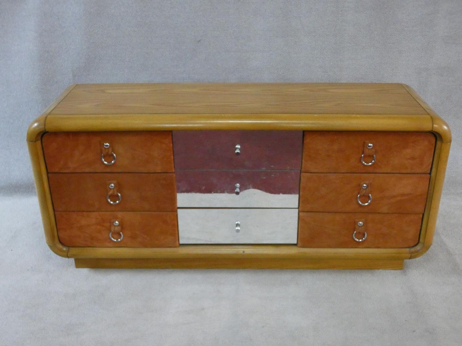 A 1970's vintage mirrored and teak chest in the Art Deco style fitted with nine drawers. H.76xW.