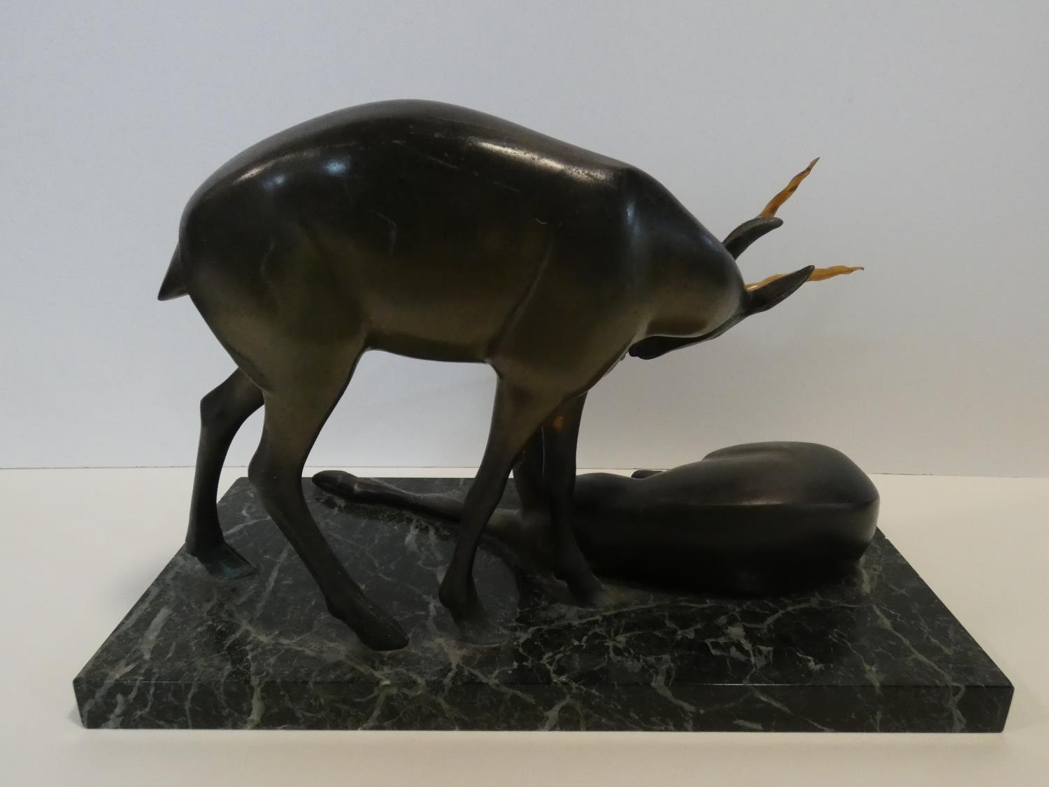 A pair of spelter Art Deco male and female gazelles mounted on a black and white veined marble base. - Image 5 of 7