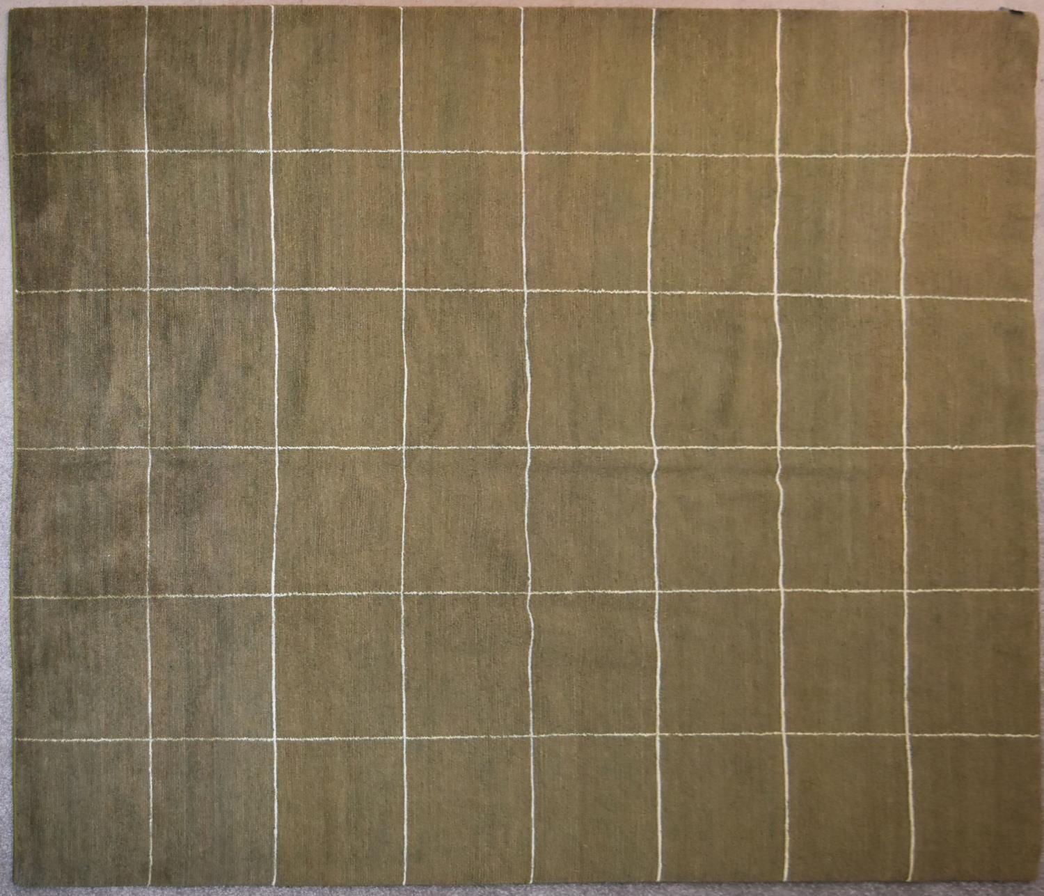 A contemporary rug with windowpane check on a beige green background. L.254x201cm