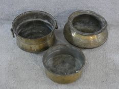 Three vintage hammered brass Indian Handis (cooking pots). One with hinged circular handles and