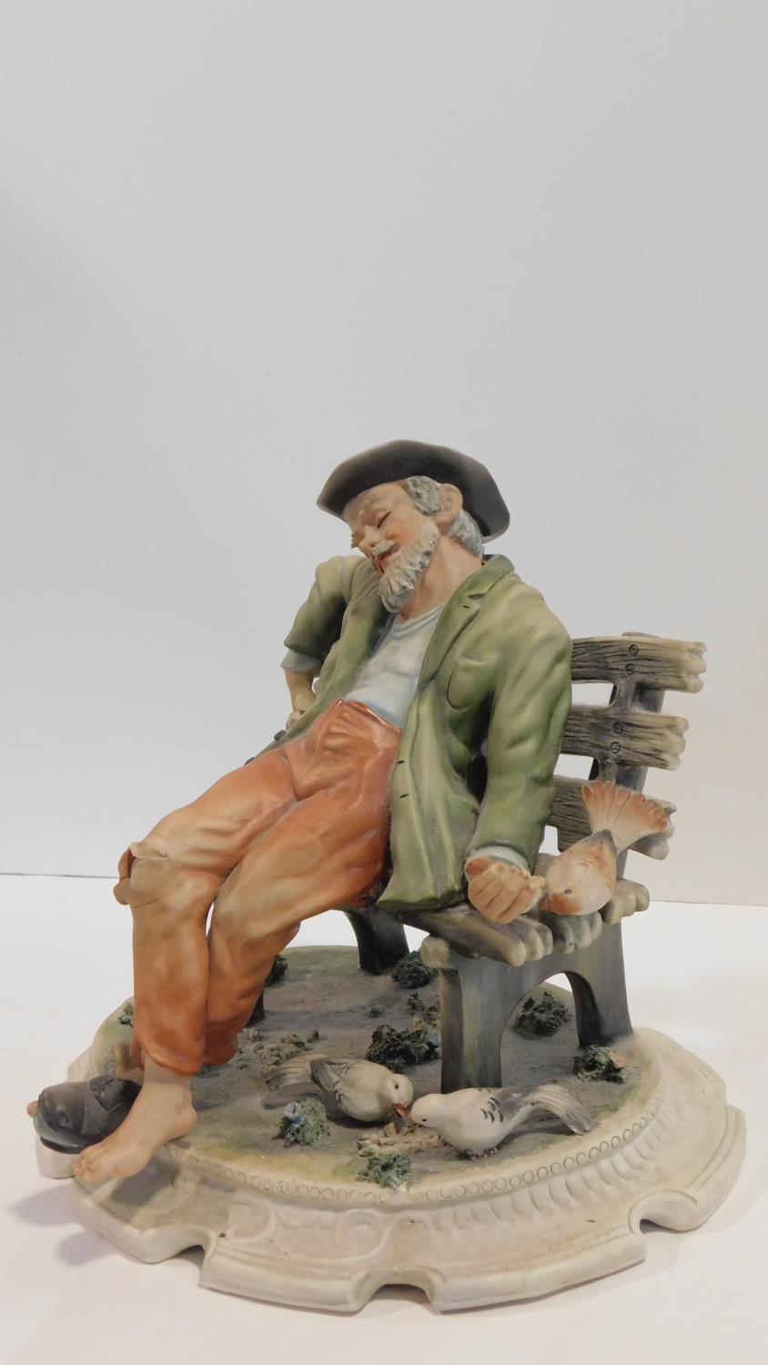 A Capodimonte figure of a man sitting on a bench, marked to the base. H.25cm - Image 2 of 5