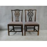 A near pair of Georgian mahogany dining chairs with pierced back splats and drop in seats on