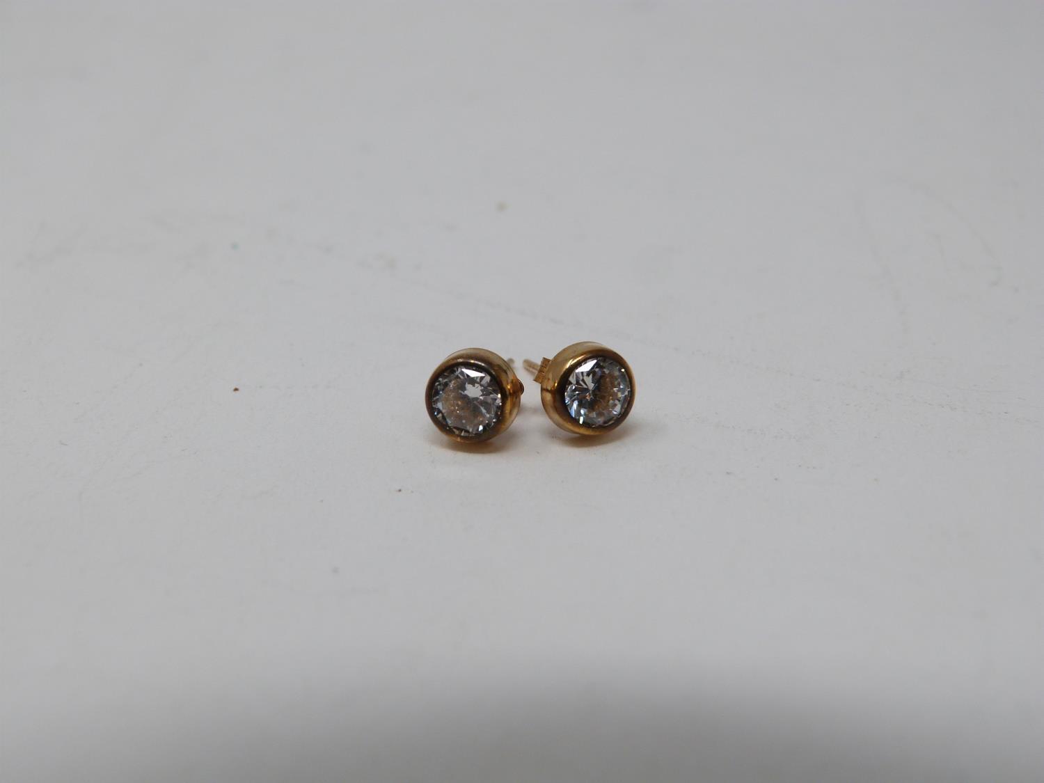 A pair of boxed 9ct yellow gold and cubic zirconia stud earrings. Posts and butterflies stamped 375. - Image 2 of 2