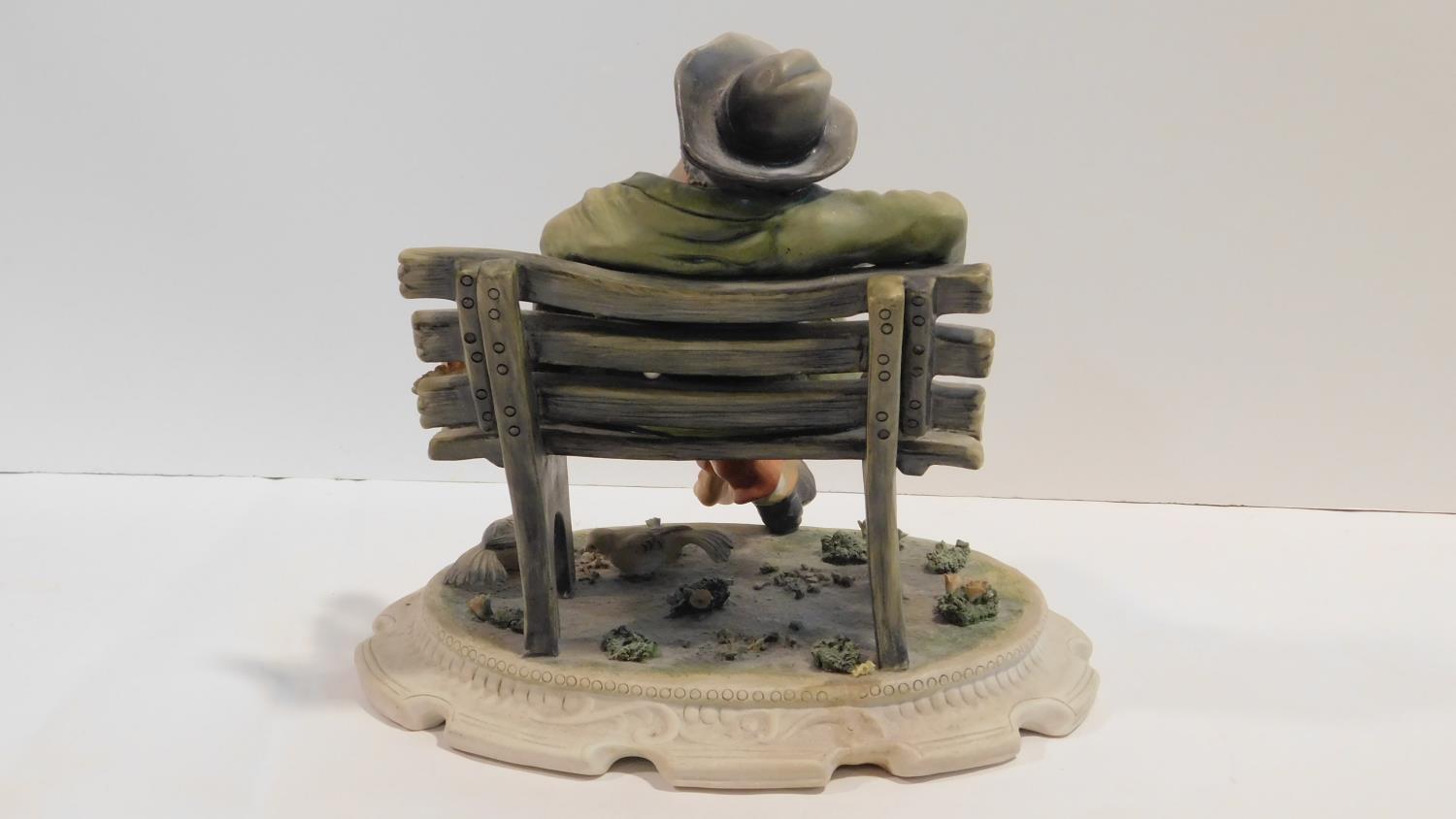 A Capodimonte figure of a man sitting on a bench, marked to the base. H.25cm - Image 3 of 5