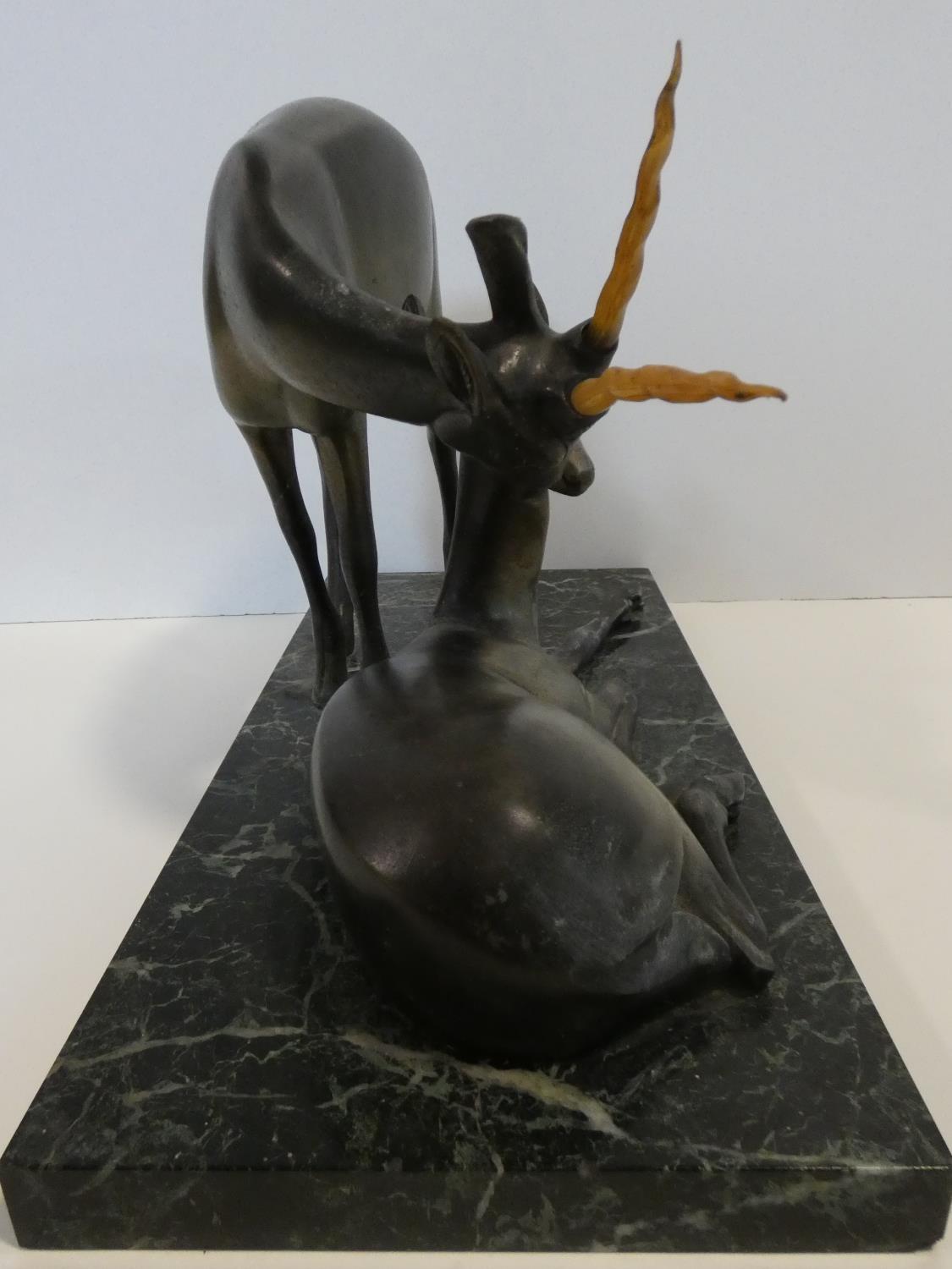 A pair of spelter Art Deco male and female gazelles mounted on a black and white veined marble base. - Image 6 of 7