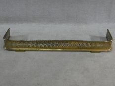 A 19th century pierced brass fire fender resting on stepped bracket feet. H.14xW.118xL.30cm