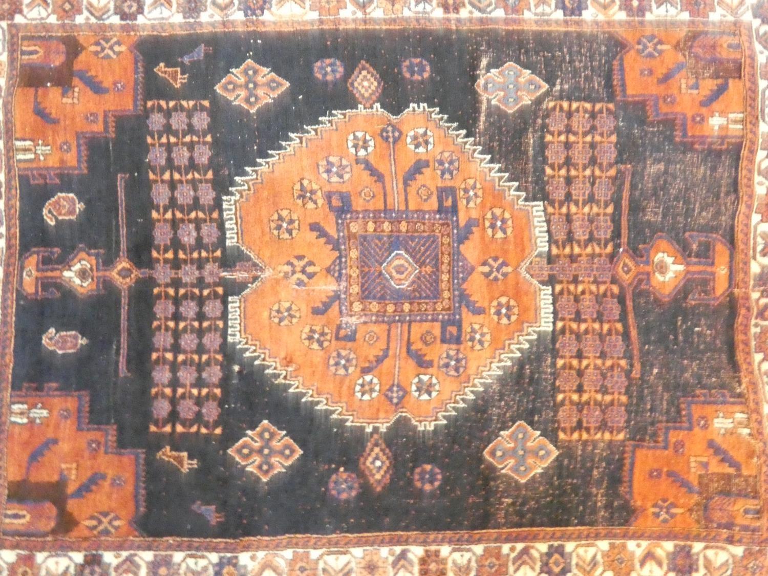 A Shirvan rug with central burgundy pole medallion on a midnight ground within stylised floral - Image 2 of 4