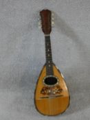 An early 20th century mandolin with mother of pearl and tortoiseshell inlay, signed Ozelli and