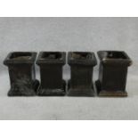 A set of four ceramic planters in grey glaze on stepped bases. H.23cm