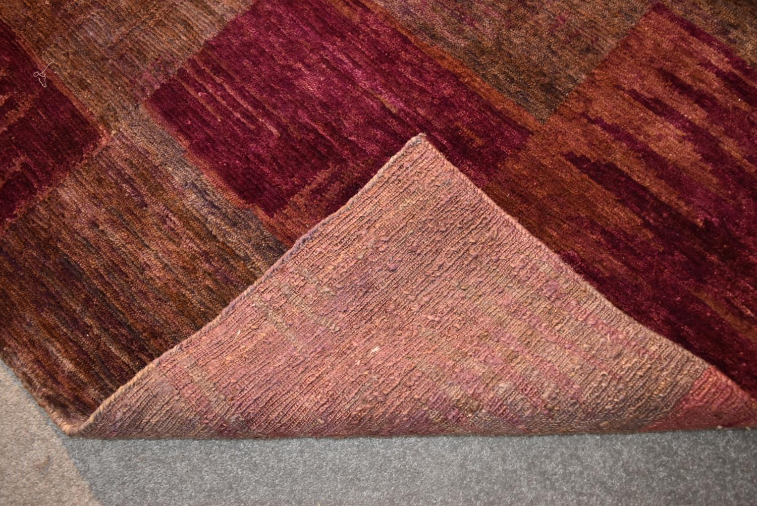 A contemporary rug with abstract chequerboard design in shades of plum. L.244x175cm - Image 4 of 4