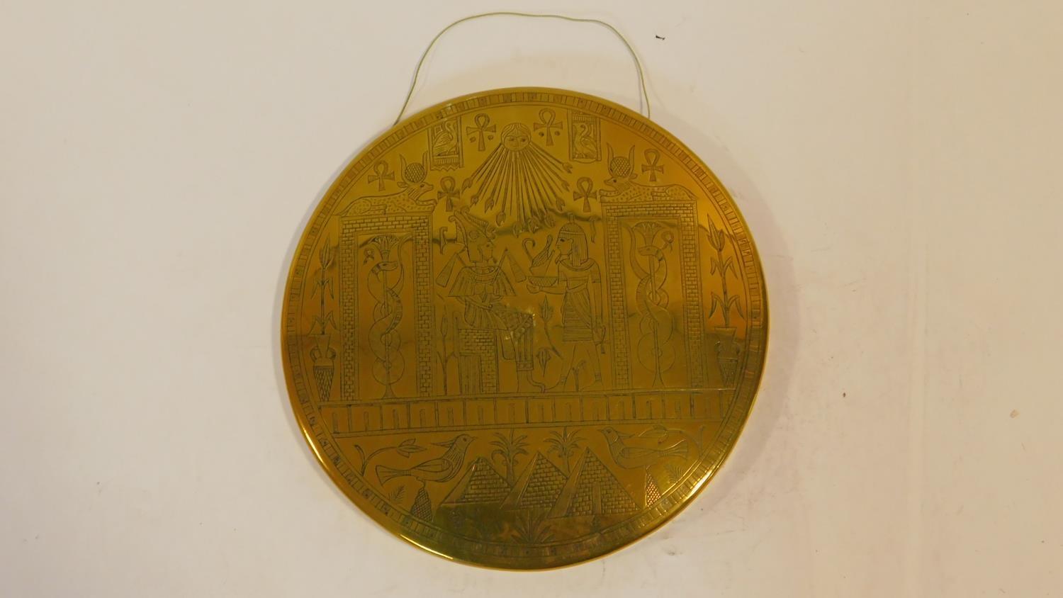 A vintage Egyptian revival engraved brass domed wall plaque with Eygptian symbols and Pharaohs.