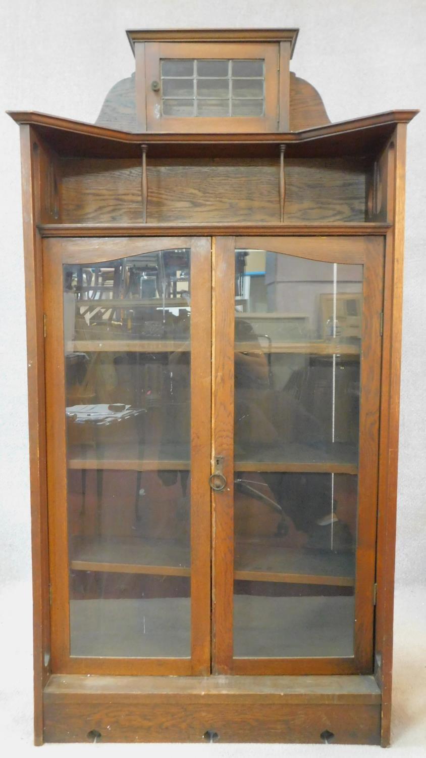 A late 19th century oak Art Nouveau bookcase in the Glasgow School style with leaded glazed