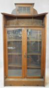 A late 19th century oak Art Nouveau bookcase in the Glasgow School style with leaded glazed