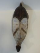 A carved and painted African DRC Gabon Fang Ngil wooden mask. H.56cm