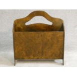 A mid century vintage laminated ply wood two section magazine basket with pierced cut carrying