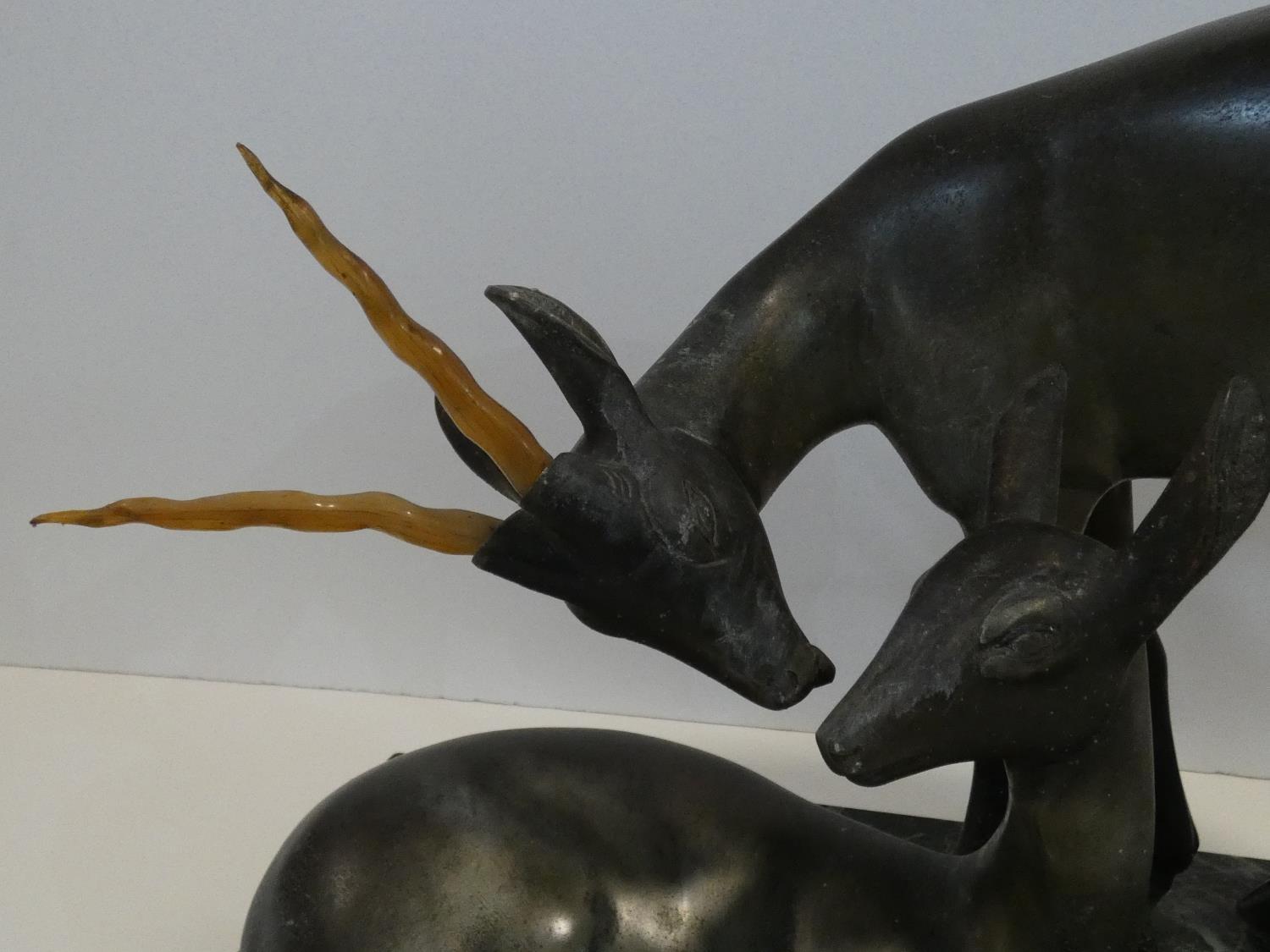 A pair of spelter Art Deco male and female gazelles mounted on a black and white veined marble base. - Image 3 of 7