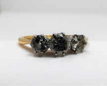 Am antique three stone diamond 18ct yellow gold and platinum ring. Set to centre with a round old