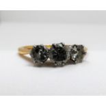 Am antique three stone diamond 18ct yellow gold and platinum ring. Set to centre with a round old