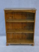 A Victorian style pine open bookcase on bun feet. H.96xW.76xL.27cm