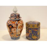 A Chinese lidded temple jar with all over Imari style decoration and a lidded hexagonal caddy with