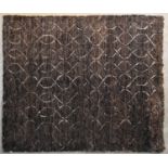 A contemporary carpet with allover scrolling interlocking pattern on a deep bronze field. L.