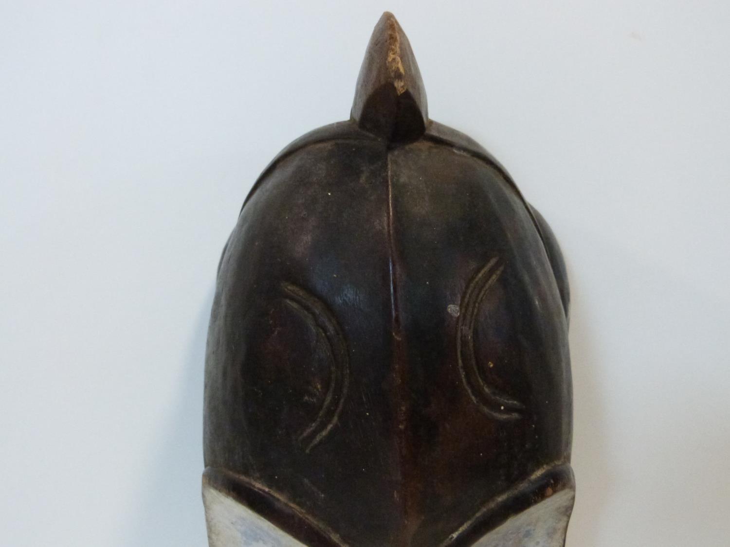 A carved and painted African DRC Gabon Fang Ngil wooden mask. H.56cm - Image 3 of 4