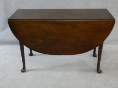 A Georgian mahogany drop flap dining table with gateleg action on slender cabriole pad foot