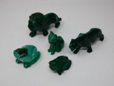 A miscellaneous collection of carved malachite animal figures to include prowling lions, a seated