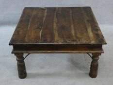An Indian iron bound hardwood low table on circular section supports. H.42xW.80xL.80cm