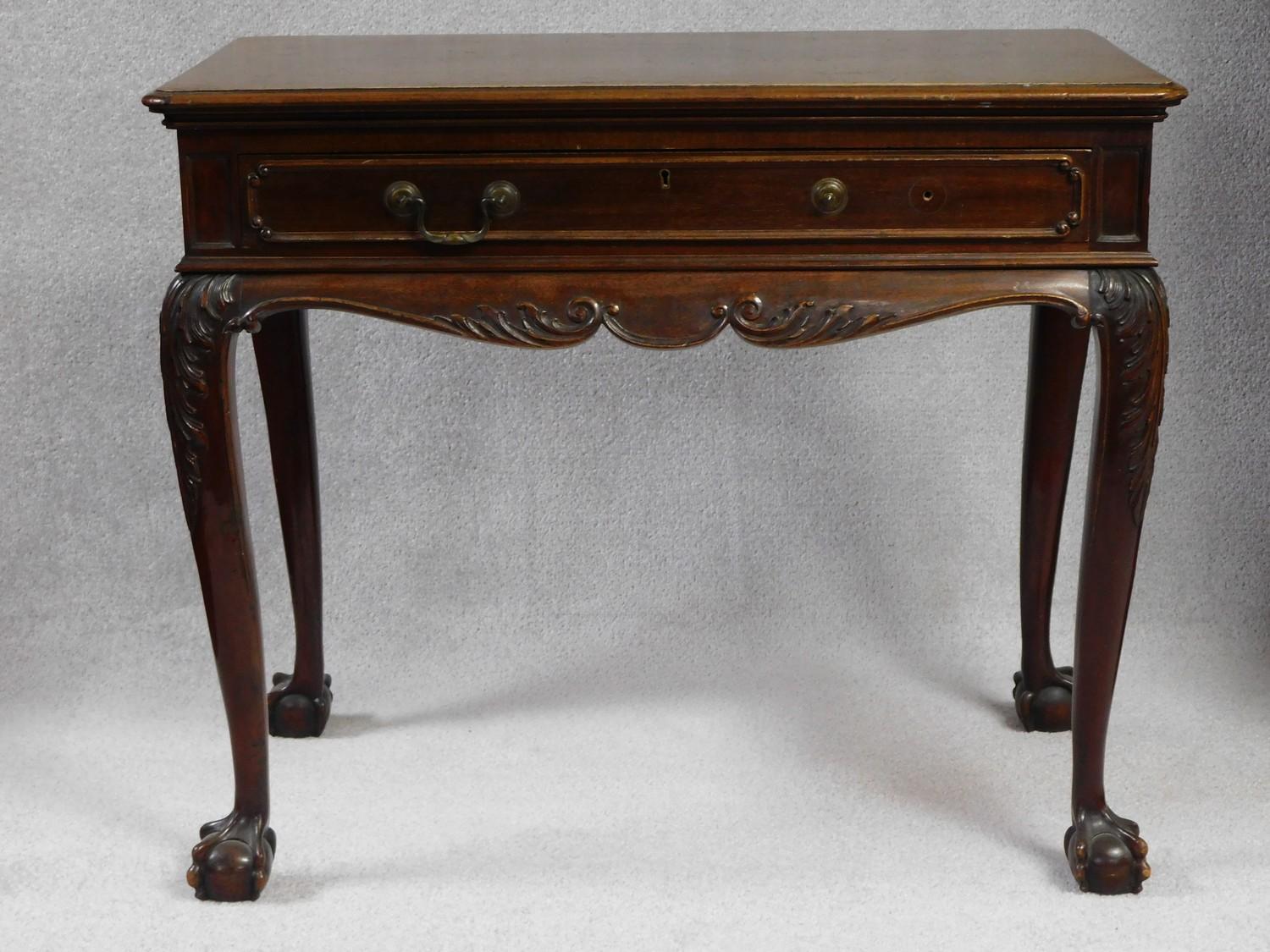 A 19th century mahogany side table in the Irish Georgian style with frieze drawer above carved