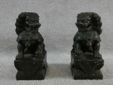 A pair of Chinese carved greenstone seated Dogs of Fo figures. H.23cm