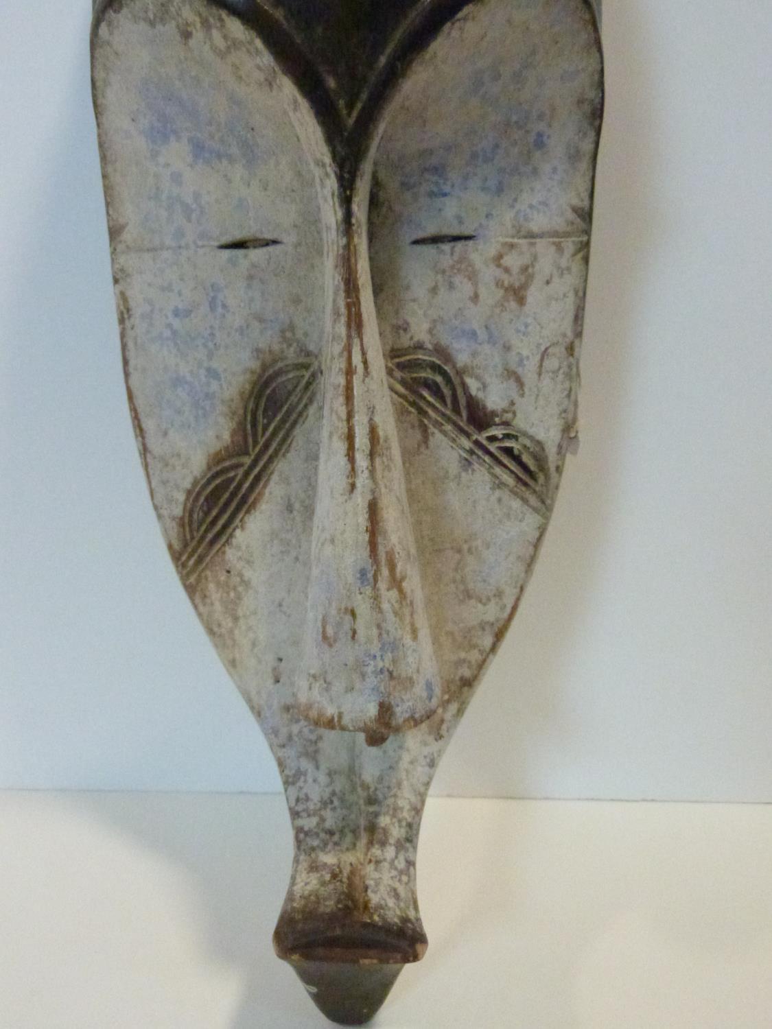 A carved and painted African DRC Gabon Fang Ngil wooden mask. H.56cm - Image 2 of 4