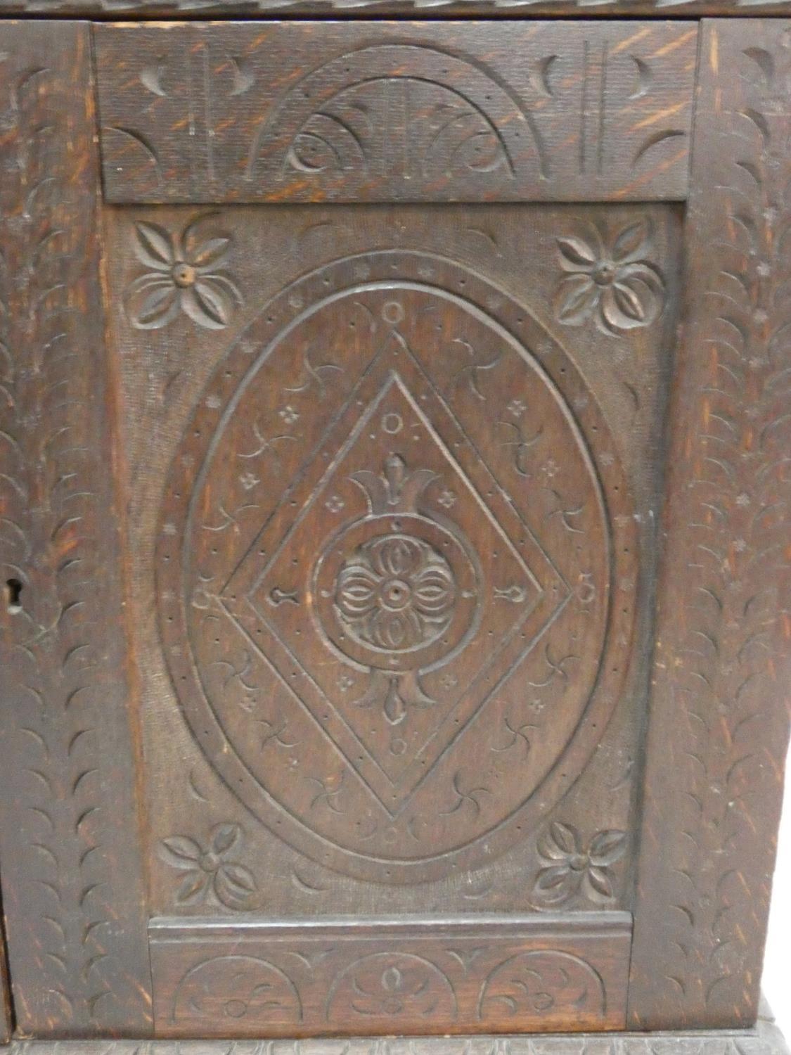 An antique country oak hall cupboard with a pair of carved panel doors on bracket feet. H.64 W.82 - Image 3 of 7