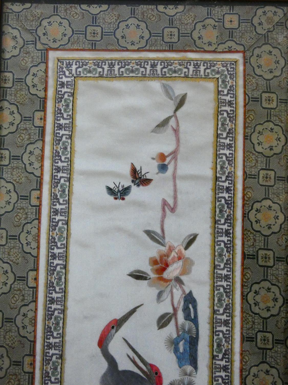 A framed and glazed Chinese panel, storks and foliate decoration within a stylized flowerhead - Image 2 of 5