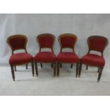 A set of four Victorian mahogany hooped back dining chairs in burgundy velour upholstery on reeded