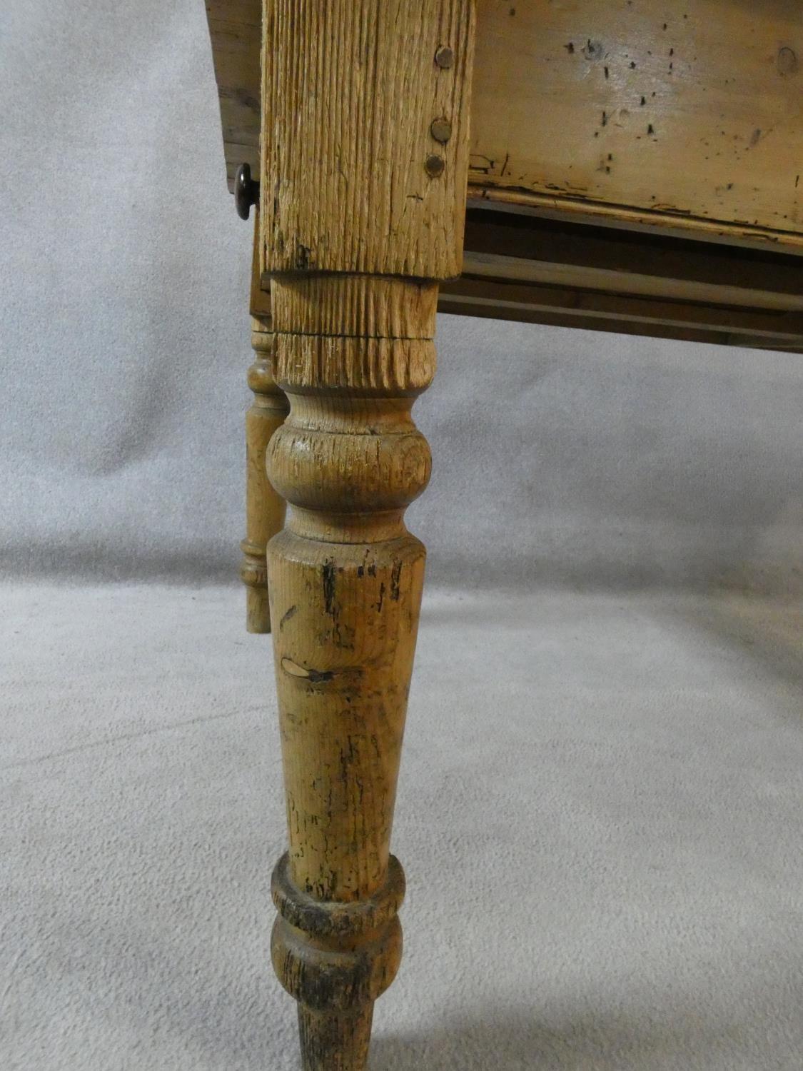 A Victorian pine kitchen dining table with planked top and end drawer on turned tapering supports. - Image 15 of 16