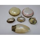 A collection of sea shell trinket boxes, three made from clam shells and three made from sections of