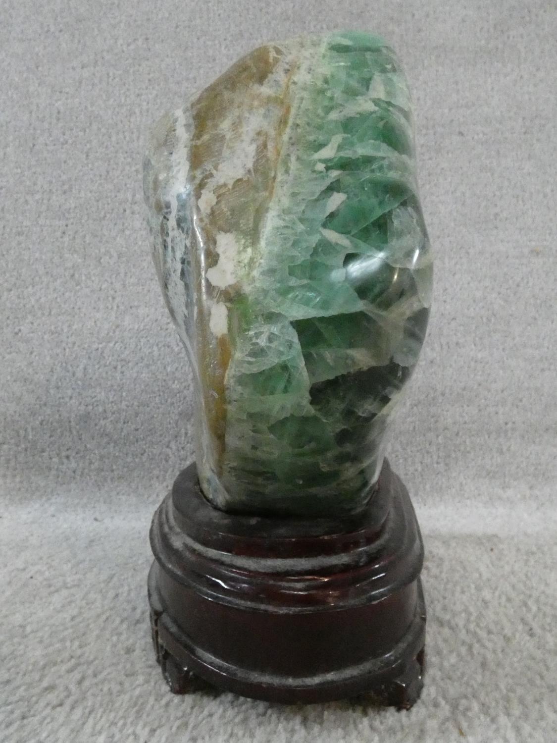 A large polished Fluorite crystal boulder mounted on a carved Chinese wooden stand. H.31cm - Image 4 of 4