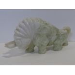 A large carved Chinese Jade bull sculpture with engraved floral motifs. L.35cm