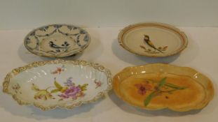 Four antique hand painted plates. Inlcluding a ceramic plate with a painted Spiderwort, two