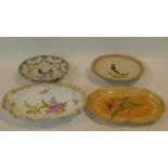 Four antique hand painted plates. Inlcluding a ceramic plate with a painted Spiderwort, two