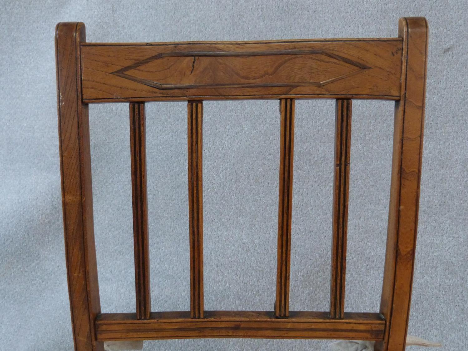 A set of four antique country elm dining chairs with carved rail backs and rush drop in seats. Three - Image 4 of 8