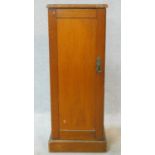 A 19th century pine pot cupboard with painted faux grained panel door enclosing shelves on plinth