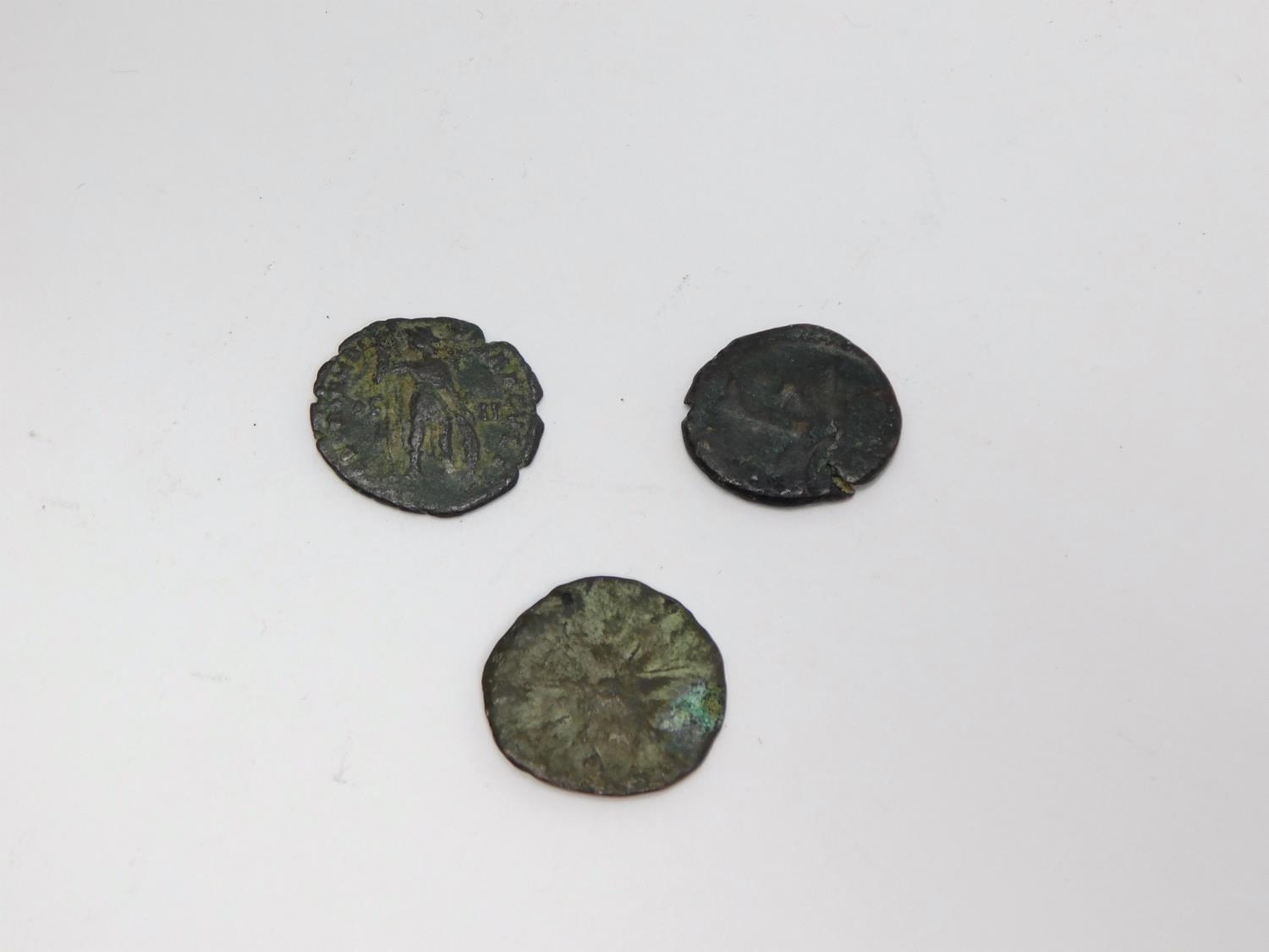 Three ancient bronze coins. One with profile of an Emperor with wreath around his head one side - Image 2 of 2