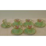 An antique Imperial Bone China five person tea set, gilded with 22kt gold and hand painted with a